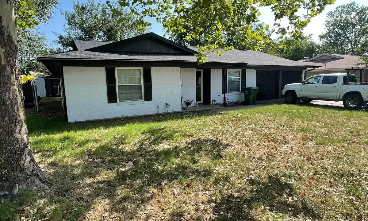Professional roofing crew working on a residential roof in Woodstock